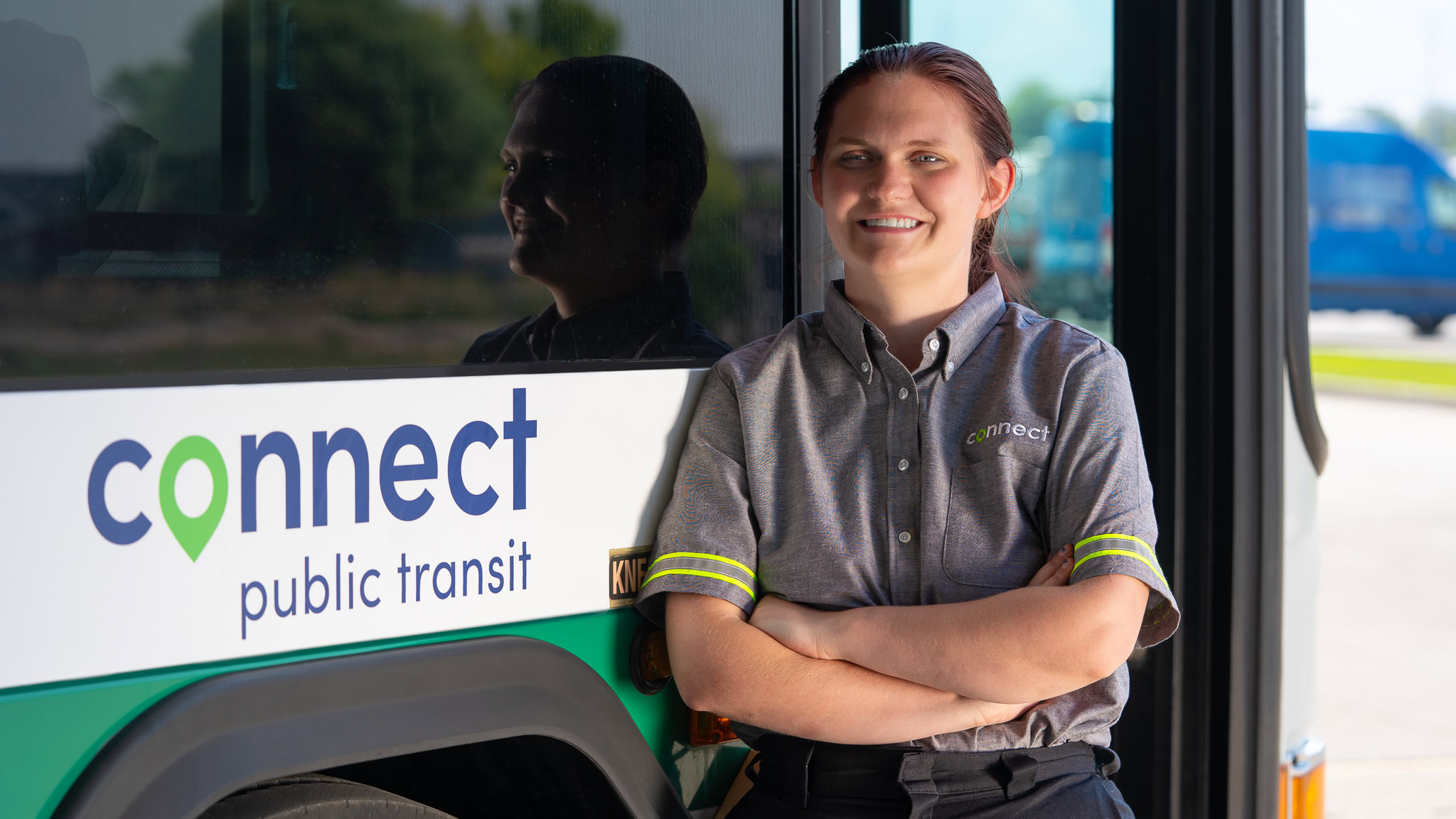 connect transit employee in front of a connect transit bus