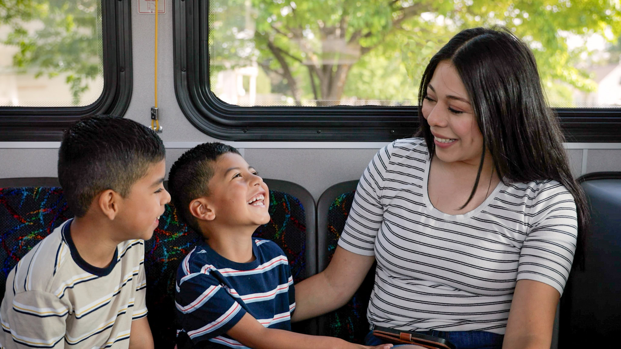 mother and children enjoying a ride on a connect transit bus