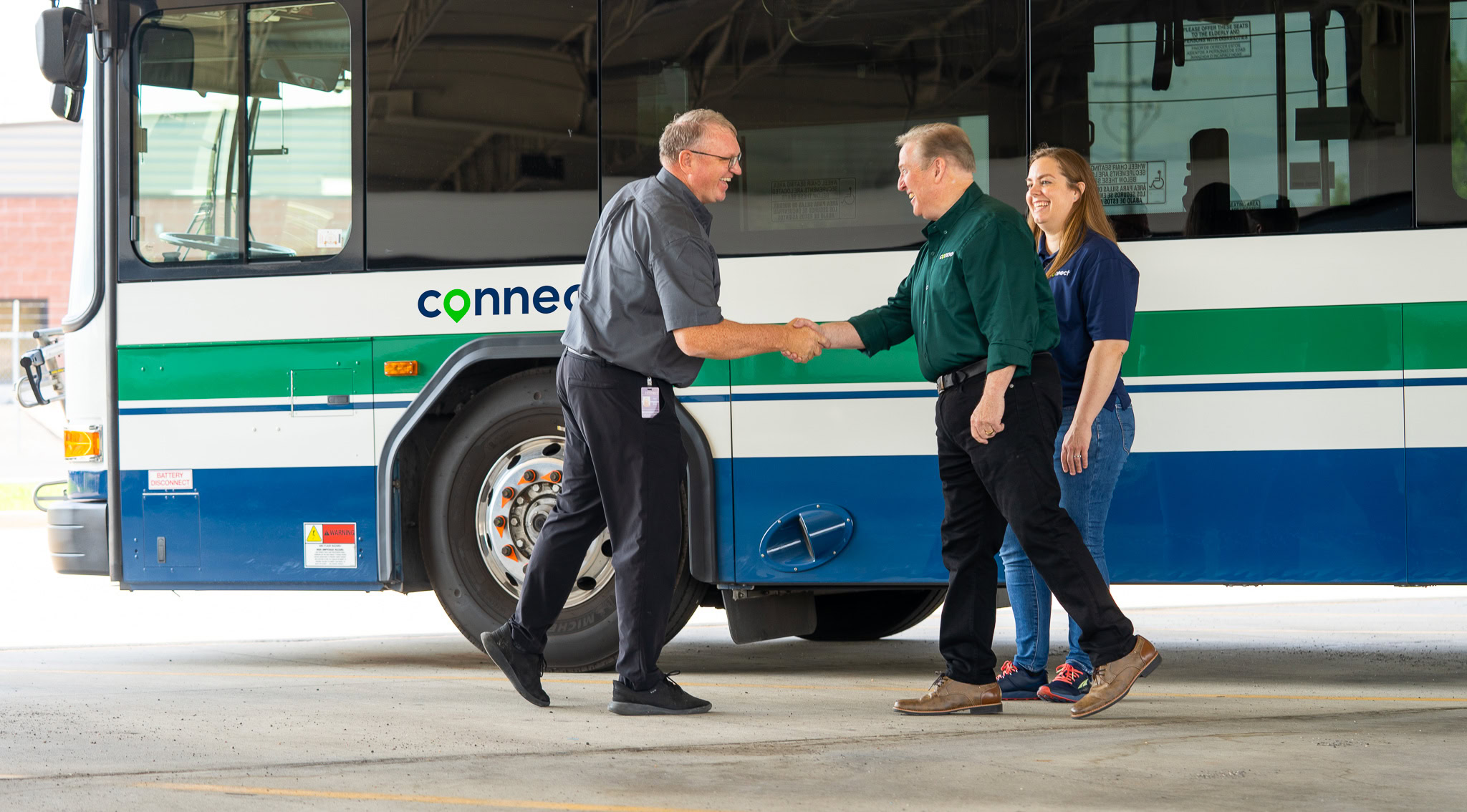 connect transit employees in front of a connect transit bus