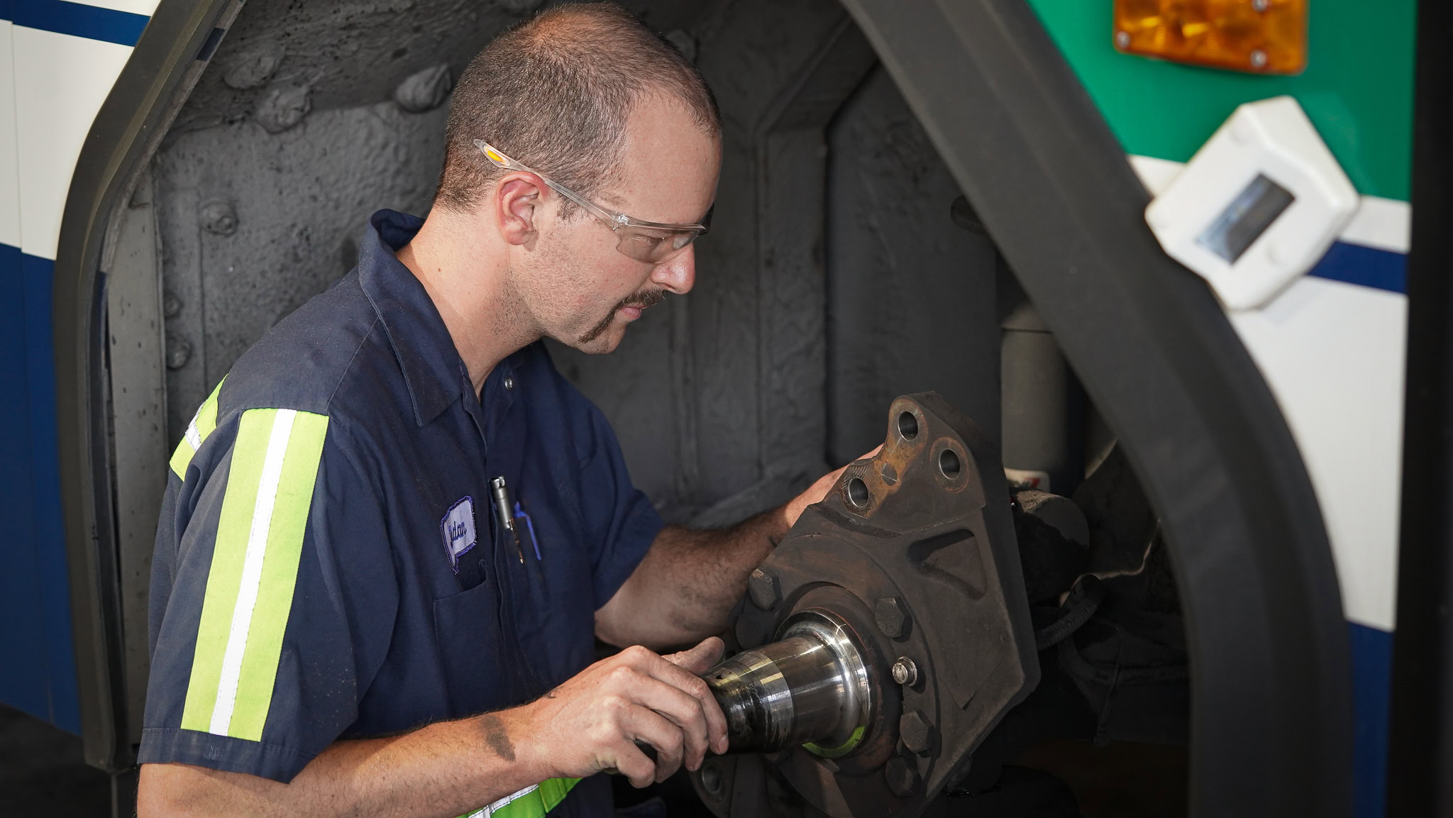 connect transit mechanic working on a connect transit bus