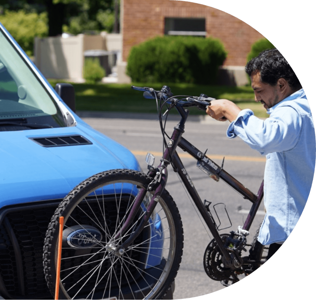 man loading a bike on a connect transit bus